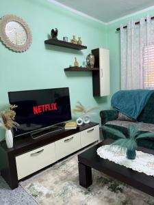 a living room with a television on a table at Sweet Escape in Shkodër