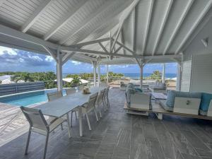 a patio with a table and chairs and a pool at GPSA83 - 8 pax in Fouché