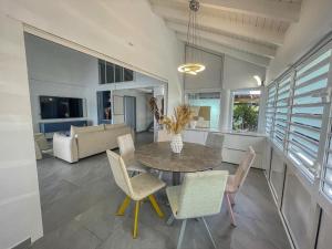 a dining room and living room with a table and chairs at GPSA83 - 8 pax in Fouché