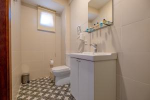 a white bathroom with a toilet and a sink at Oldsophia hotels in Istanbul +5 photos