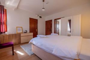 a bedroom with a large white bed and a chair at Oldsophia hotels in Istanbul