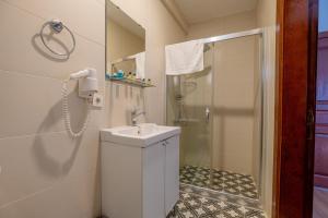 a bathroom with a shower and a sink and a phone at Oldsophia hotels in Istanbul
