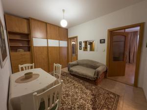 a bedroom with a bed and a table and chairs at Retro apartment with three rooms in Bratislava +1 photo