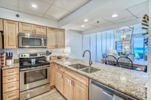 a kitchen with a sink and a stove top oven at HP 15W Salt and Light by 30A Escapes in Rosemary Beach