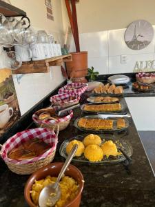 a buffet with many different types of food on a counter at Hotel Fazenda Vitoria in Pindorama