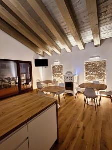 a room with tables and chairs and a stove at Maria Luisa Mountain Lodge in Rovere