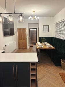 a kitchen with a table and a dining room at NEW Luxury Neath Center Stay in Neath