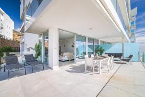 a patio with chairs and a table on a building at Med2holidays in Fuengirola