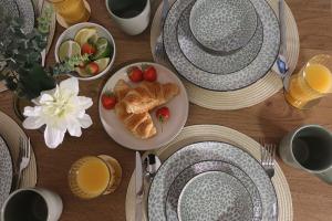 a table with a plate of croissants and strawberries on it at Henderson Home Sleeps 3 with Allocated Parking in Pallion +29 photos