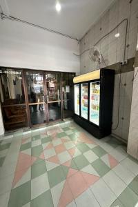 a room with a soda machine and a tiled floor at 98 Inn BilikXpert at Chow Kit in Kuala Lumpur