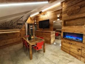 a dining room with a table and a tv at Bertuzzi Homes in Aprica