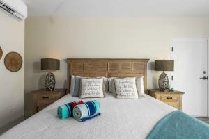 a bedroom with a bed with pillows on it at The One Love at Cottages in Sand Bluff +47 photos