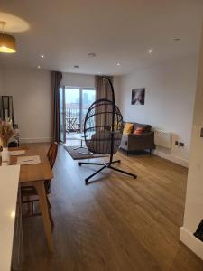 a living room with a chair and a table at Cozy one Bedroom with Views In Birmingham City Center in Birmingham