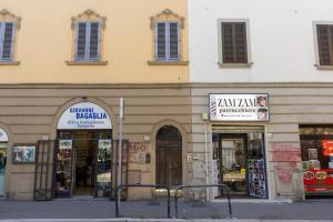 a building with shops on the side of a street at La Casina del Popi in Arezzo