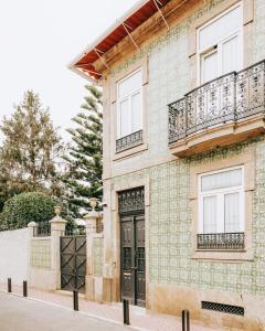 a house with a black door and a balcony at Quinta das Luzes by Casa dos Sequeiras in Vila Nova de Gaia +61 photos