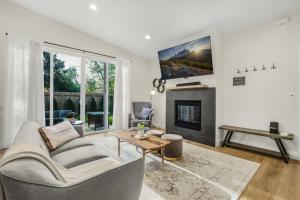 a living room with a couch and a fireplace at Amazing and Comfy Home With A Fire Place and Big Backyard in Orchards