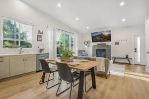 a kitchen and dining room with a table and chairs at Amazing and Comfy Home With A Fire Place and Big Backyard in Orchards