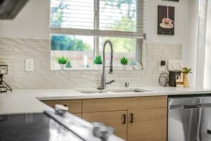 a kitchen with a sink and a window at Amazing and Comfy Home With A Fire Place and Big Backyard in Orchards +29 photos