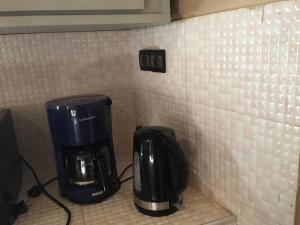 a coffee maker and coffeemaker sitting on a counter at maison rio la rufisquoise in Saly Portudal