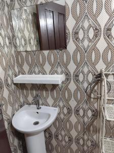 a bathroom with a sink and a mirror at maison rio la rufisquoise in Saly Portudal +48 photos