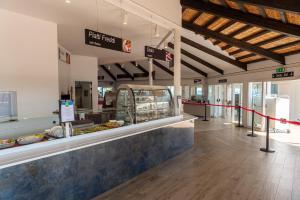 a food court with a counter in a store at Houses and Apts. in Albarella 24882 in Palazzo Vianello +29 photos