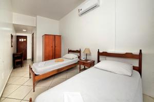 Ένα ή περισσότερα κρεβάτια σε δωμάτιο στο Hotel Macabu