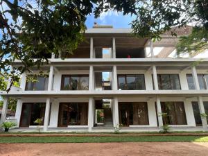 an external view of a building with large windows at Lily Mirissa in Mirissa