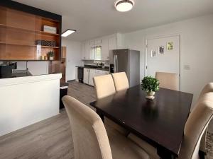a kitchen and dining room with a table and chairs at Golden Acres in Calming Caldwell in Caldwell