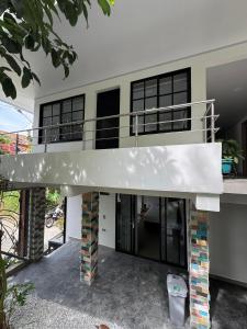 a large house with a staircase in front of it at Casa Bosque Vivo in Norcasia