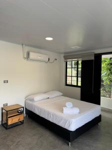 a bedroom with a large bed and a window at Casa Bosque Vivo in Norcasia