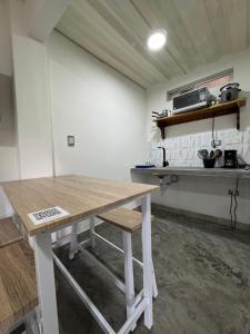a kitchen with a wooden table in a room at Casa Bosque Vivo in Norcasia