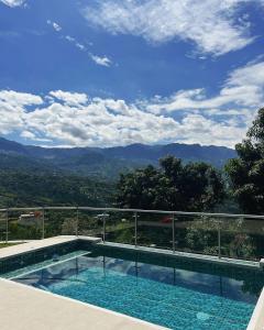 a swimming pool with a view of the mountains at Dalusa House in Tena