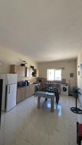 a kitchen with a table in the middle of it at Fgura Spacious Apartments in Tal-Liedna