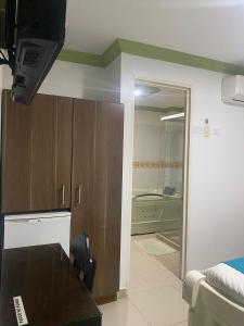 a living room with a couch and a television in a room at HOTEL NOGAL PLAZA in La Virginia