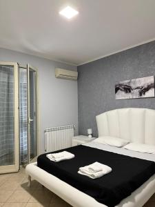 a bedroom with a large bed with two towels on it at Fun House in Trabia