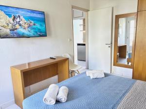 a bedroom with a bed with two towels on it at Villa Vasilis in Bali