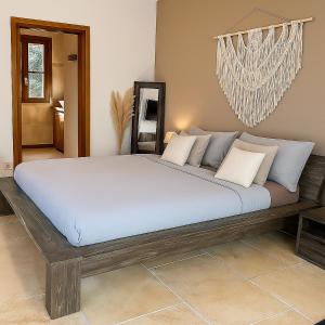 a bedroom with a large bed in a room at Casetta di Asciaghju in Porto-Vecchio