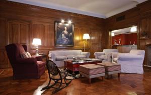a living room filled with furniture and a table at Solar De La Plaza in Salta