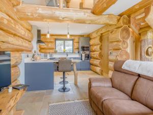 a kitchen and living room in a log cabin at Hope Hideaway 