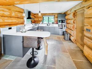 a kitchen with wooden walls and a white table in a room at Hope Hideaway 