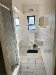 a bathroom with a toilet and a sink at Black chilli accommodation in Brackenfell +6 photos