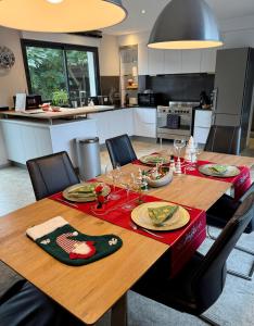a kitchen with a wooden table with a red napkin on it at KeschtaLoft - Gîte classé 4 étoiles in Châtenois