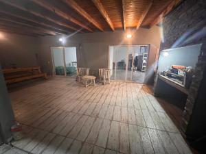 an empty room with a table and chairs in it at Quinta Los Barrera in Cañuelas