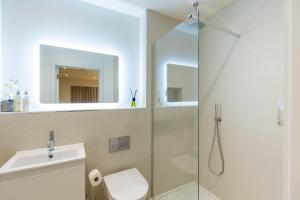 a bathroom with a shower and a toilet and a sink at Mudeford Beach Guest Room in Mudeford +20 photos