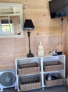 a room with a shelf with baskets and a lamp at Evermore Stay in Richmond