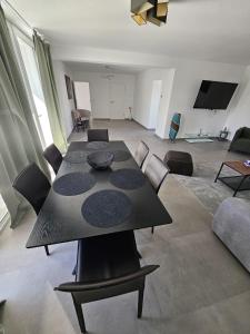 a dining table and chairs in a living room at UZ Villa 11 - Modern Living Laatzen in Hannover