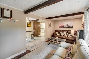 a living room with a couch and a table at Easy Cleveland Access! Quiet Suburb Stay with Yard in Oakwood