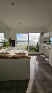 a bedroom with a bed and a view of the ocean at La petite Croisière - Vue Mer in Jard-sur-Mer