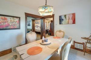 a dining room with a wooden table and chairs at Central Akron Stay! Large Victorian Home with Yard in Akron