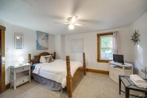 a bedroom with a bed and a television in it at Central Akron Stay! Large Victorian Home with Yard in Akron